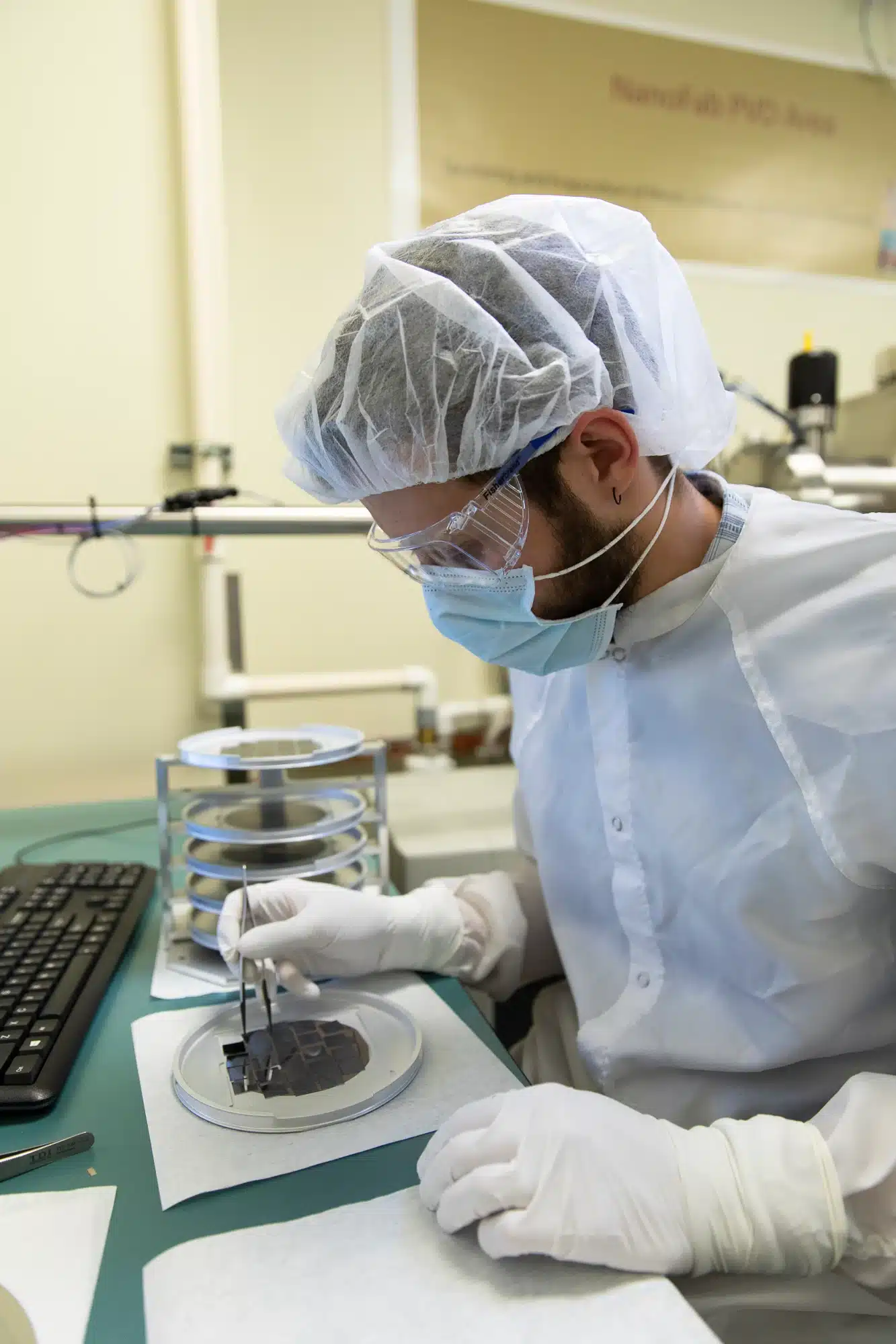 A man performing microscopy and nanofabrication in a lab.