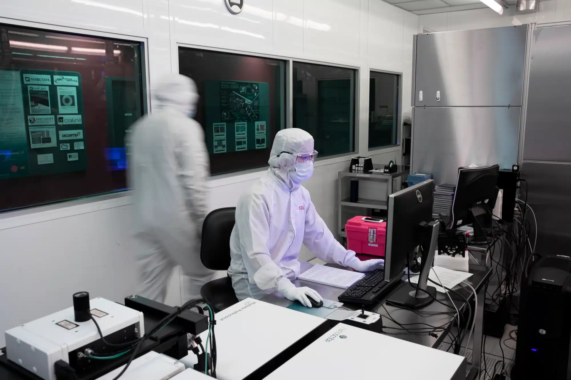 A group of people performing spectroscopy and microscopy characterization in a lab.