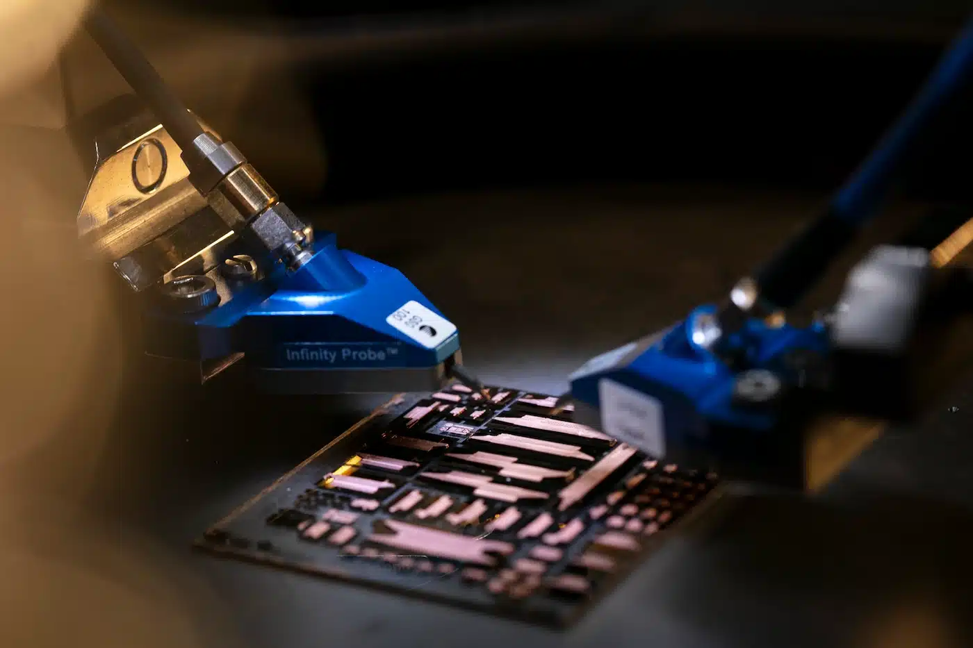 A machine is performing nanofabrication on a circuit board.